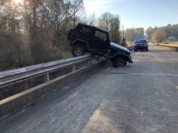 7:52 AM.  Jeep Hanging On Guard Rail In Bay Springs