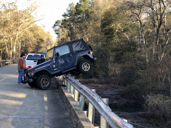 7:52 AM.  Jeep Hanging On Guard Rail In Bay Springs